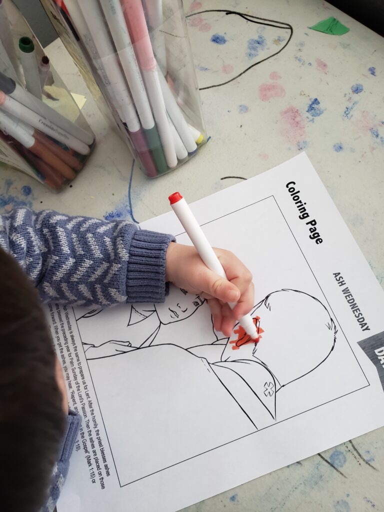 toddler coloring an Ash Wednesday coloring page