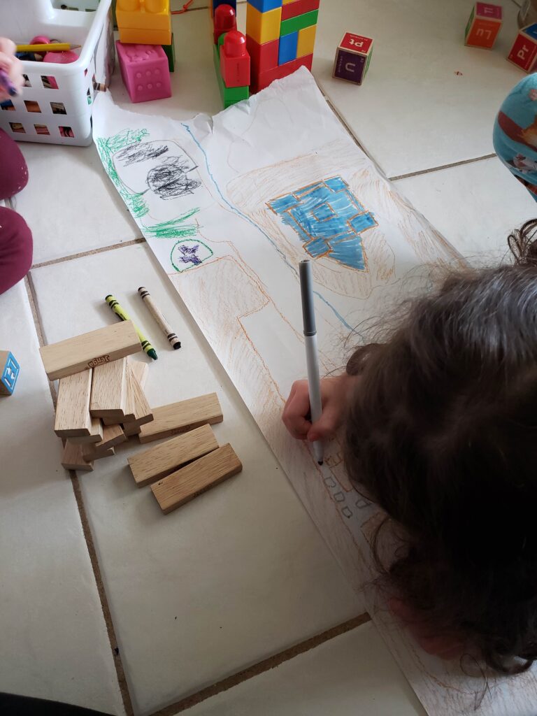 Kids preparing Holy Week Jerusalem map for Holy Week Homeschool activties