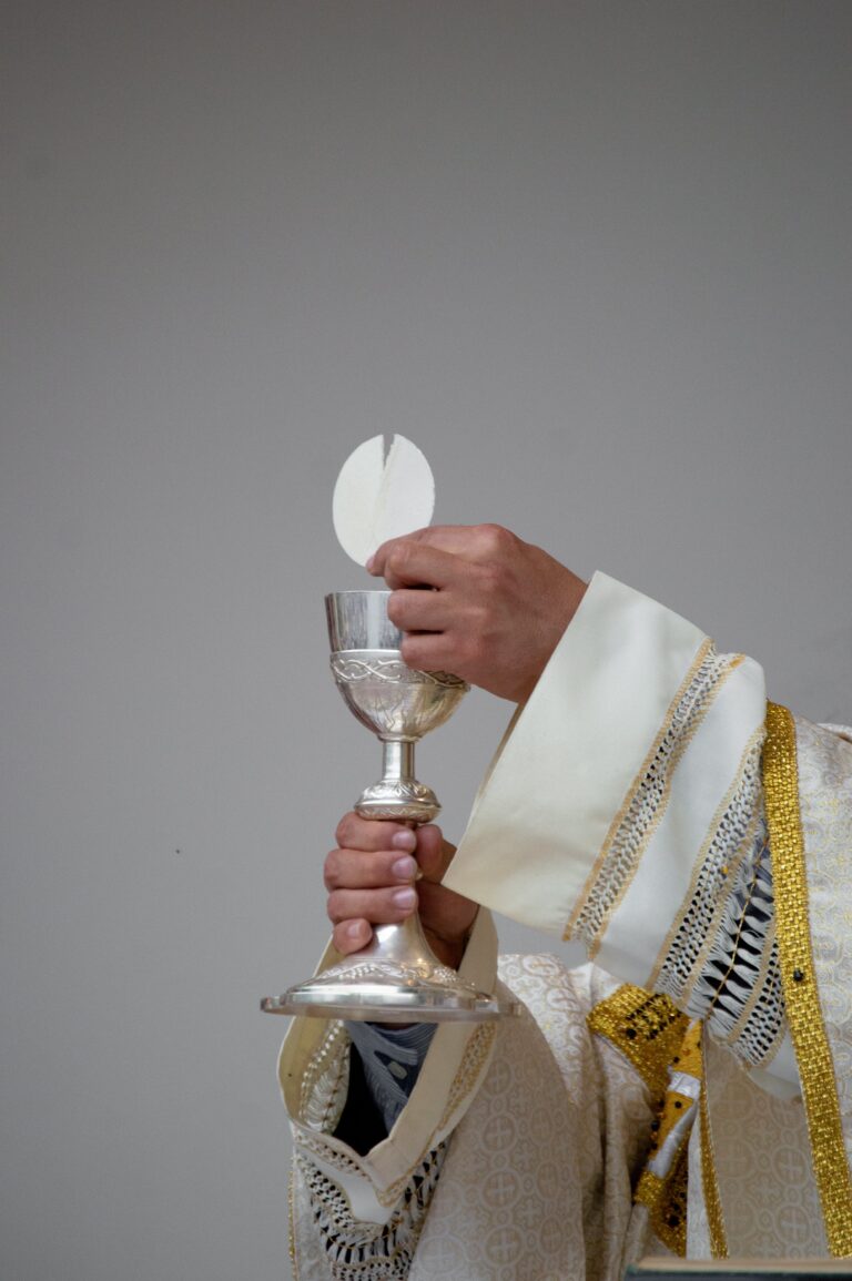 Priest holding the Precious Body and Blood of Jesus