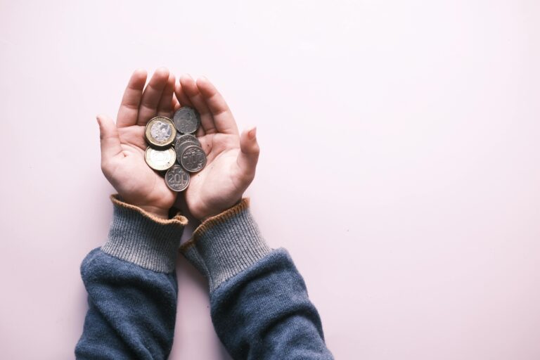 child holding silver coins